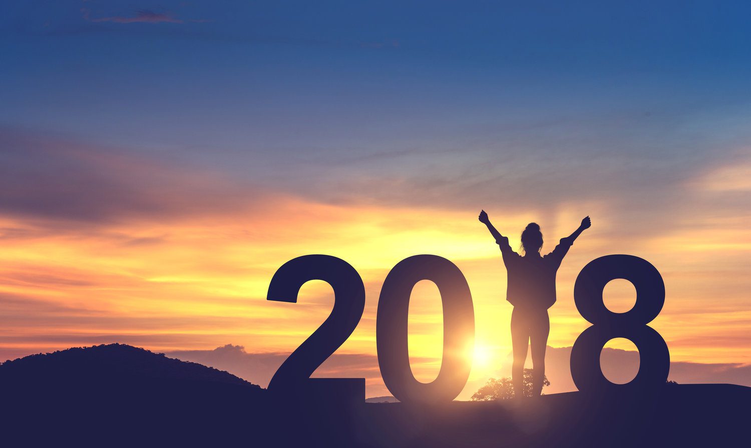 Woman enjoying on the hill and 2018 years while celebrating new year